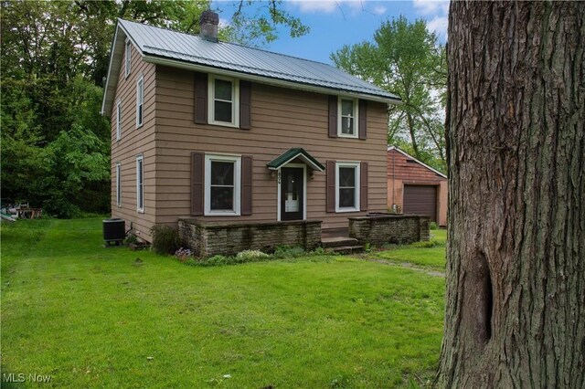 804 Hollywood Ave, East Liverpool, OH 43920 - view of front facade featuring a chimney, cooling unit, a front lawn, and metal roof