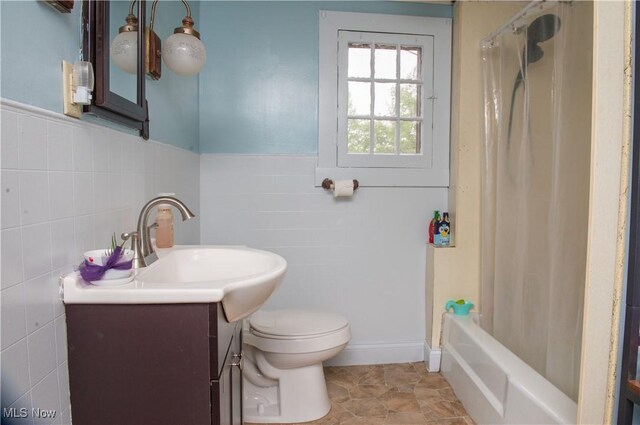 804 Hollywood Ave, East Liverpool, OH 43920 - full bathroom with tile walls, vanity, toilet, shower / bath combination with curtain, and a wainscoted wall