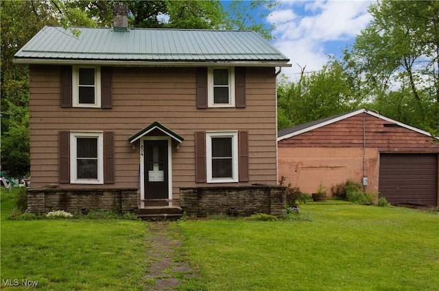 804 Hollywood Ave, East Liverpool, OH 43920 - colonial-style house featuring a front lawn, a chimney, metal roof, and entry steps