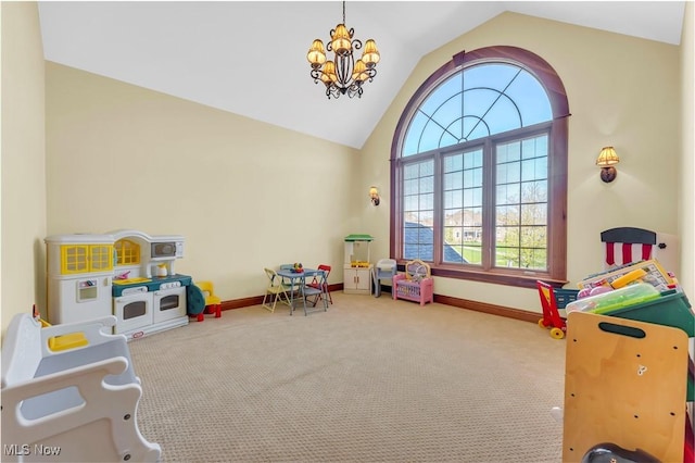 recreation room with vaulted ceiling, carpet, a chandelier, and baseboards