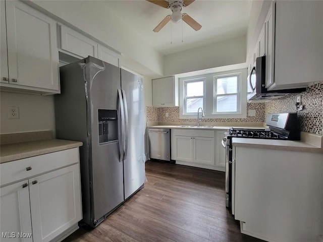621 Noah Ave, Akron, OH 44320 - kitchen with appliances with stainless steel finishes, a sink, backsplash, dark wood-type flooring, and a ceiling fan