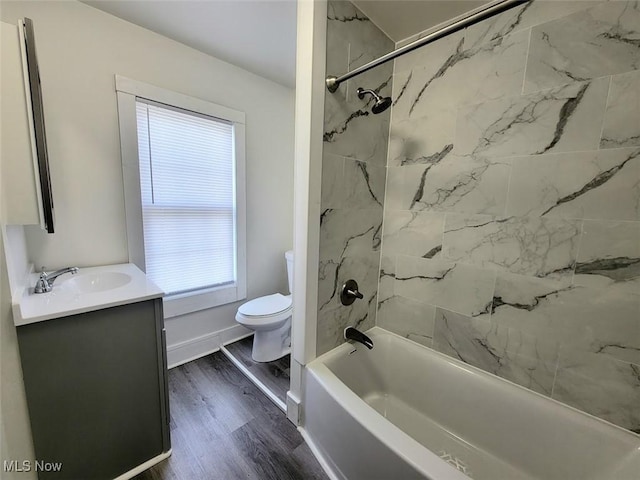 621 Noah Ave, Akron, OH 44320 - bathroom featuring toilet, vanity, wood finished floors,  shower combination, and plenty of natural light