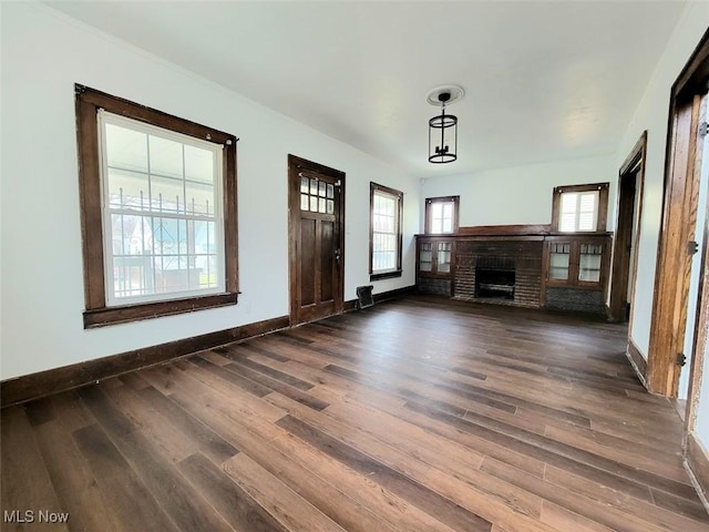 621 Noah Ave, Akron, OH 44320 - unfurnished living room featuring wood finished floors, a fireplace, and baseboards