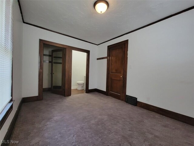 621 Noah Ave, Akron, OH 44320 - unfurnished bedroom with crown molding, carpet floors, and baseboards