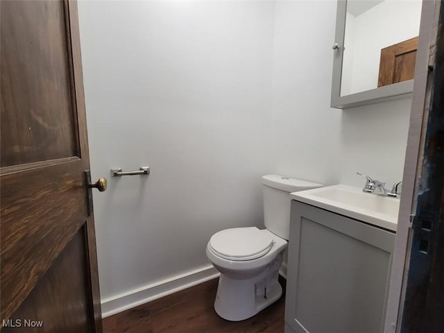 621 Noah Ave, Akron, OH 44320 - half bath with wood finished floors, toilet, vanity, and baseboards