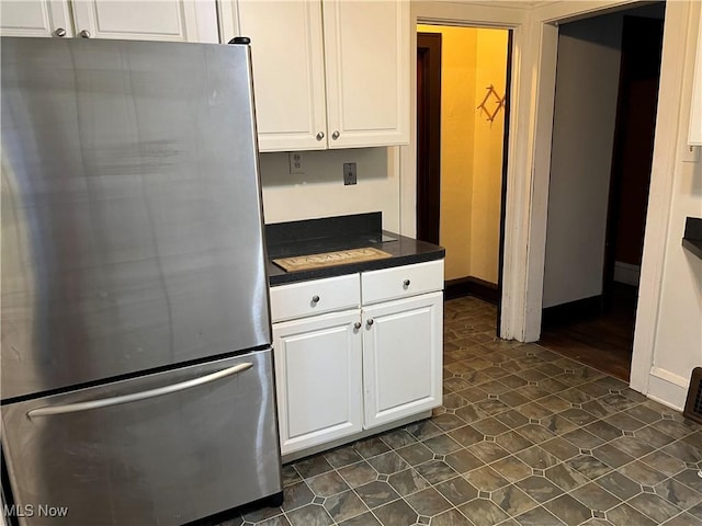 3657 Ludgate Rd, Shaker Heights, OH 44120 - kitchen featuring freestanding refrigerator, dark countertops, and white cabinetry