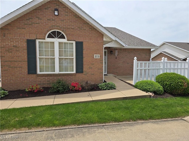2457 Barrington Way, Wooster, OH 44691 - view of front facade featuring fence, brick siding, and a shingled roof