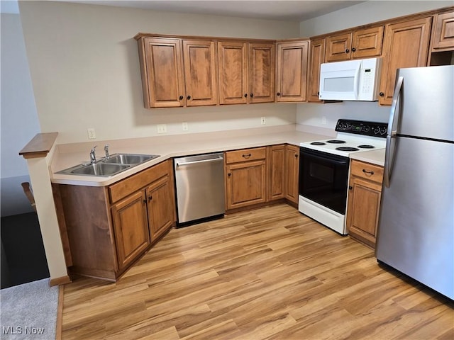 2457 Barrington Way, Wooster, OH 44691 - kitchen with appliances with stainless steel finishes, a sink, light wood-type flooring, and brown cabinets