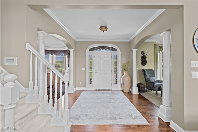 915 Creek View Dr, Aurora, OH 44202 - entrance foyer with arched walkways, ornamental molding, dark wood finished floors, decorative columns, and baseboards
