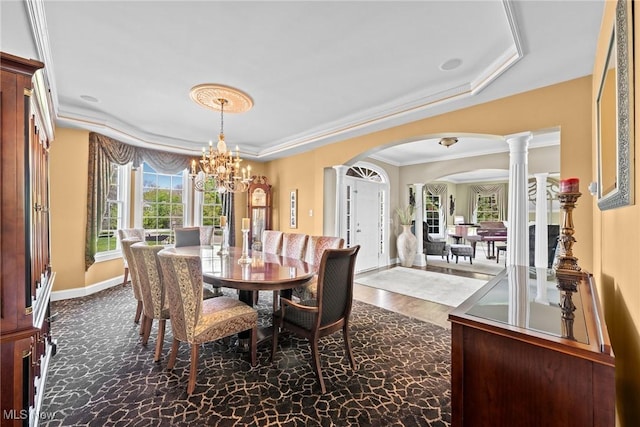 915 Creek View Dr, Aurora, OH 44202 - dining area with a raised ceiling, arched walkways, a chandelier, baseboards, and ornamental molding