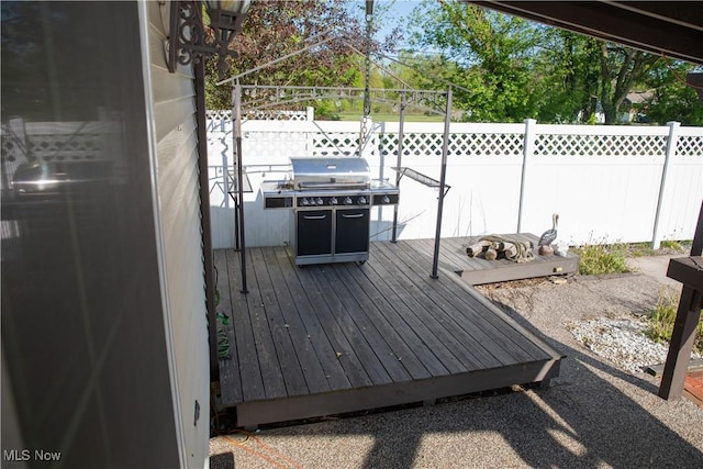 deck with area for grilling and fence
