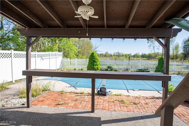 view of patio featuring fence and a ceiling fan