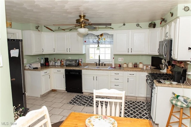 kitchen featuring a sink, appliances with stainless steel finishes, a ceiling fan, and white cabinets