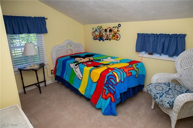 bedroom with carpet flooring, baseboards, and vaulted ceiling
