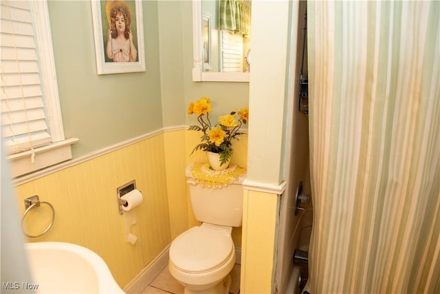 bathroom with toilet and wainscoting