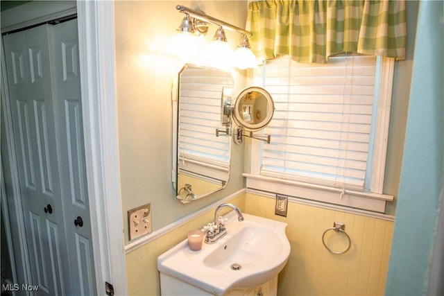 bathroom with a sink and wainscoting