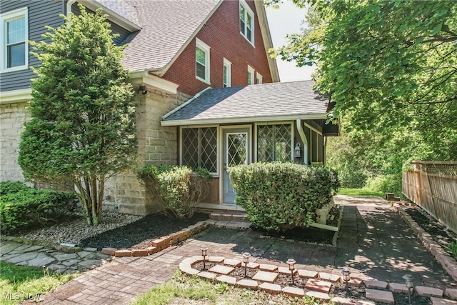 899 Park Blvd W, East Liverpool, OH 43920 - back of property with roof with shingles, fence, stone siding, and a patio