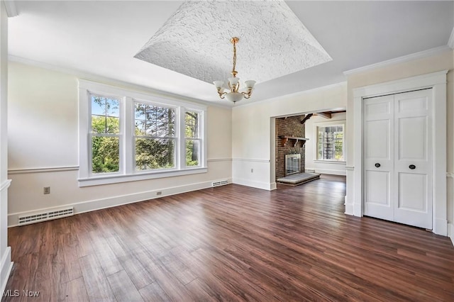 899 Park Blvd W, East Liverpool, OH 43920 - unfurnished living room with a chandelier, dark wood finished floors, a fireplace, ornamental molding, and a tray ceiling