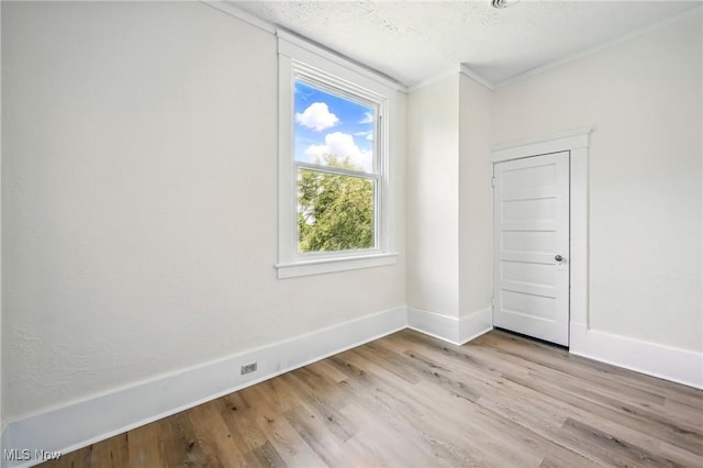 899 Park Blvd W, East Liverpool, OH 43920 - spare room featuring wood finished floors, ornamental molding, baseboards, and a textured ceiling