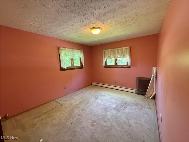 6855 Painesville Ravenna Rd, Concord, OH 44077 - spare room with a baseboard heating unit, carpet floors, a textured ceiling, and baseboards