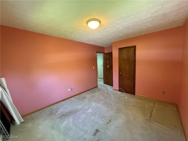6855 Painesville Ravenna Rd, Concord, OH 44077 - unfurnished room with carpet, baseboards, and a textured ceiling