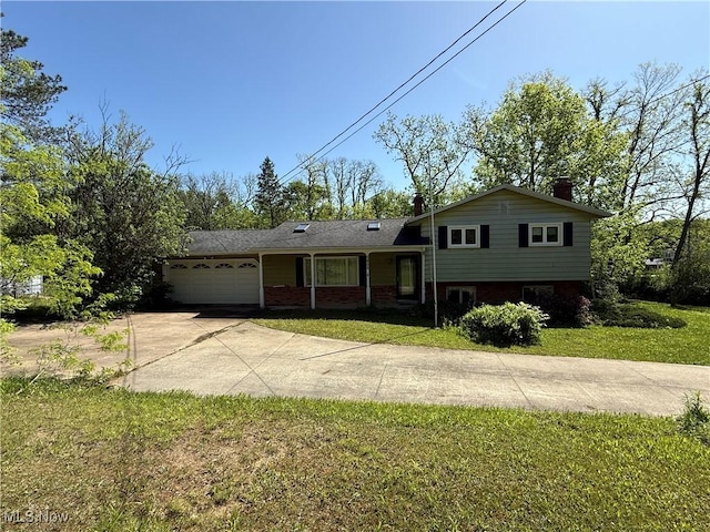 6855 Painesville Ravenna Rd, Concord, OH 44077 - split level home featuring an attached garage, concrete driveway, a front lawn, brick siding, and a chimney