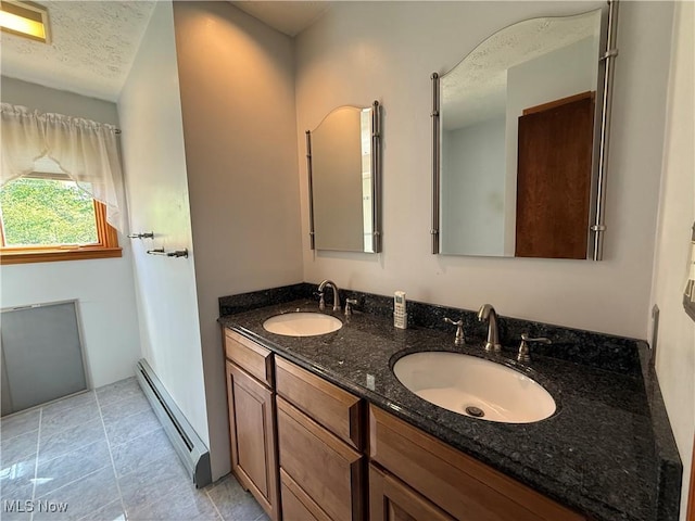 6855 Painesville Ravenna Rd, Concord, OH 44077 - full bath with a baseboard heating unit, double vanity, and a textured ceiling