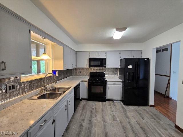 1308 17th St, Vienna, WV 26105 - kitchen featuring black appliances, a sink, light wood-style floors, light countertops, and backsplash