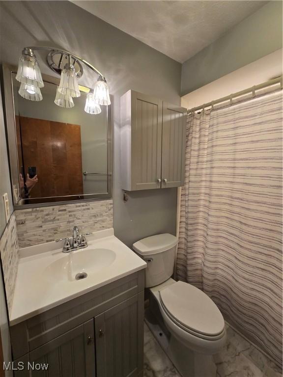 1308 17th St, Vienna, WV 26105 - full bath with vanity, toilet, marble finish floors, and decorative backsplash