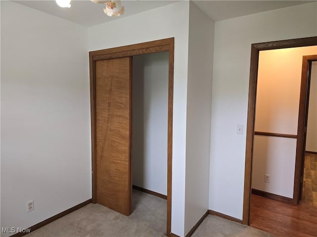1308 17th St, Vienna, WV 26105 - unfurnished bedroom with baseboards, a closet, and light carpet