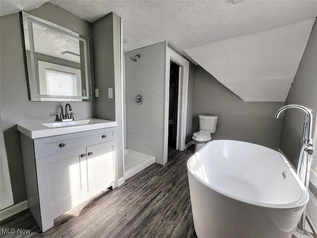 432 Fuller St, Akron, OH 44306 - full bath featuring a textured ceiling, wood finished floors, a stall shower, vanity, and a freestanding tub