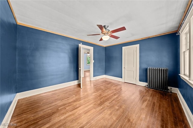 3004 Essex Rd, Cleveland Heights, OH 44118 - spare room featuring radiator heating unit, a ceiling fan, wood finished floors, baseboards, and ornamental molding