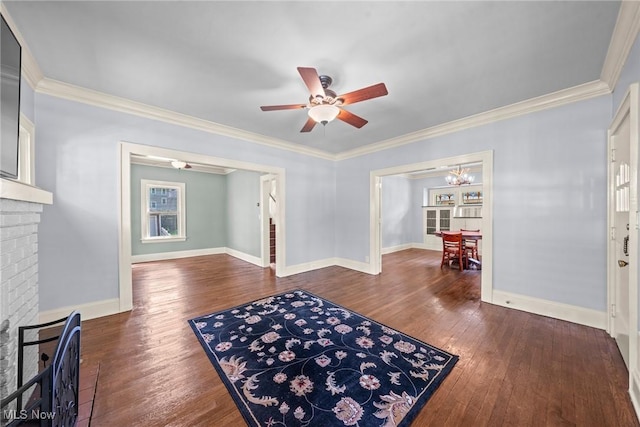 3004 Essex Rd, Cleveland Heights, OH 44118 - living room featuring a fireplace, a ceiling fan, a chandelier, dark wood-style floors, and crown molding