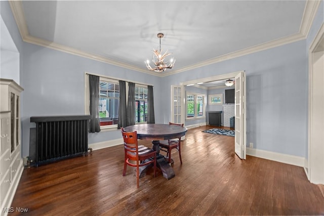 3004 Essex Rd, Cleveland Heights, OH 44118 - dining area with radiator heating unit, a chandelier, wood finished floors, a brick fireplace, and ornamental molding