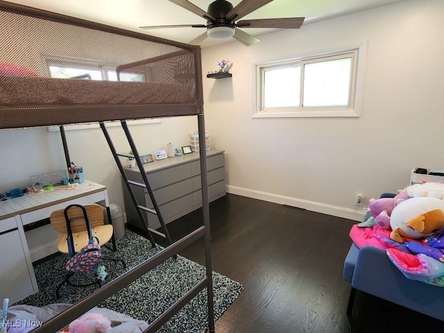 bedroom with baseboards and dark wood-type flooring