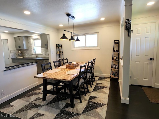 dining room featuring baseboards, plenty of natural light, and recessed lighting