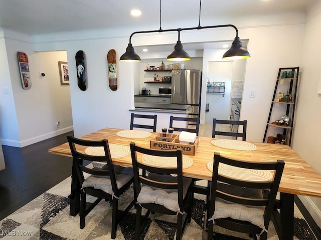 dining space with wood finished floors, recessed lighting, and baseboards