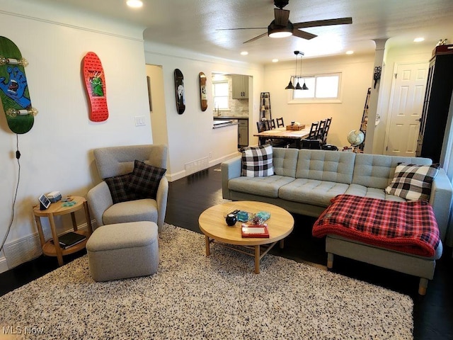 living room with a ceiling fan, wood finished floors, recessed lighting, and baseboards