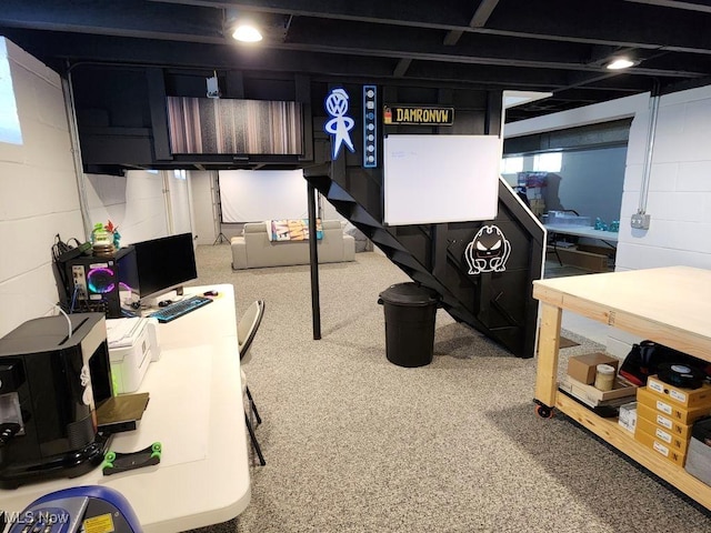 below grade area with carpet floors and concrete block wall