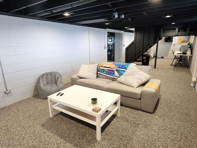 living area with stairs and carpet flooring
