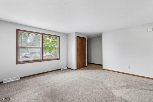 spare room with carpet floors and baseboards