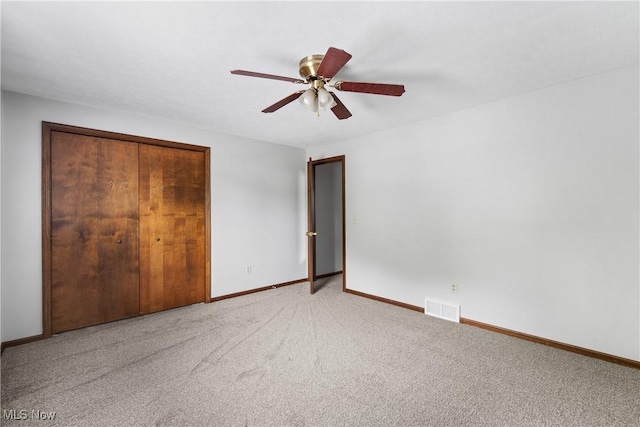 unfurnished bedroom with carpet, baseboards, and a ceiling fan