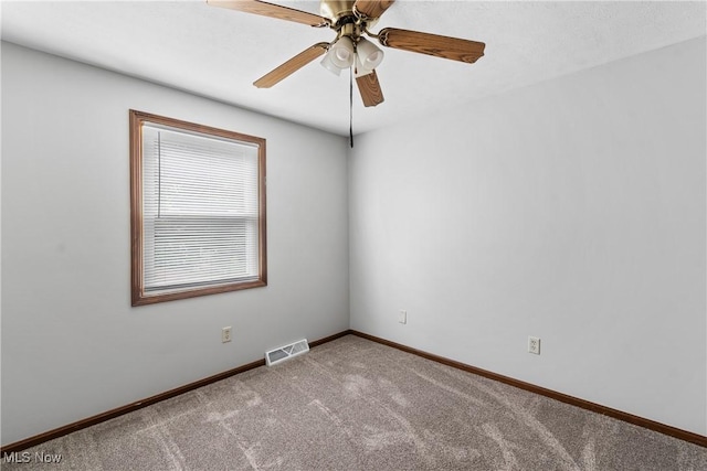 carpeted empty room with baseboards and ceiling fan