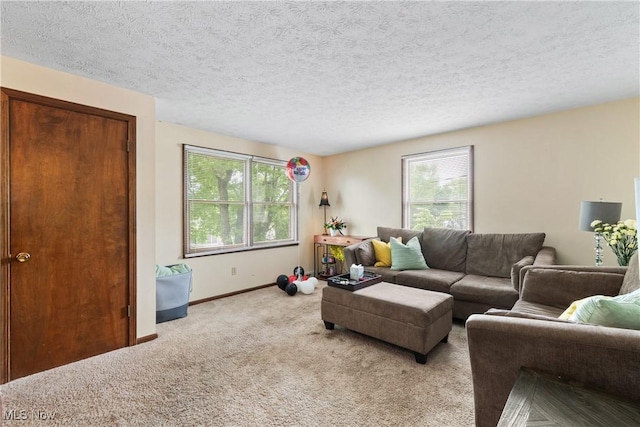 living room with carpet, plenty of natural light, baseboards, and a textured ceiling