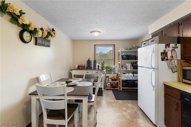 dining space featuring a textured ceiling