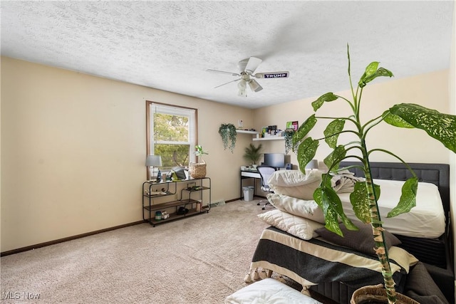 carpeted living area featuring ceiling fan and baseboards