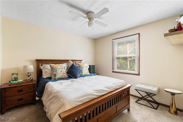 carpeted bedroom with ceiling fan and baseboards