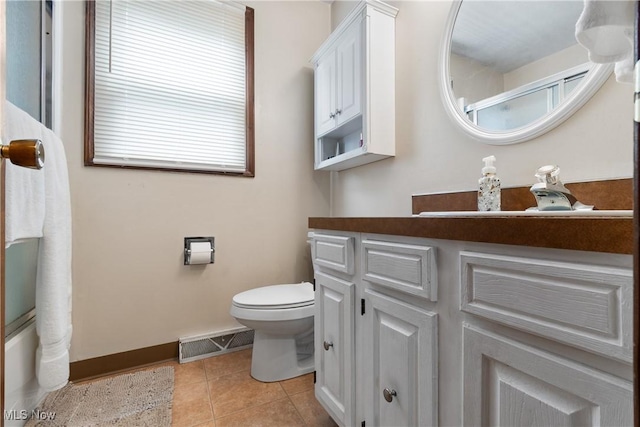 full bathroom featuring toilet, baseboards, tile patterned floors, and vanity