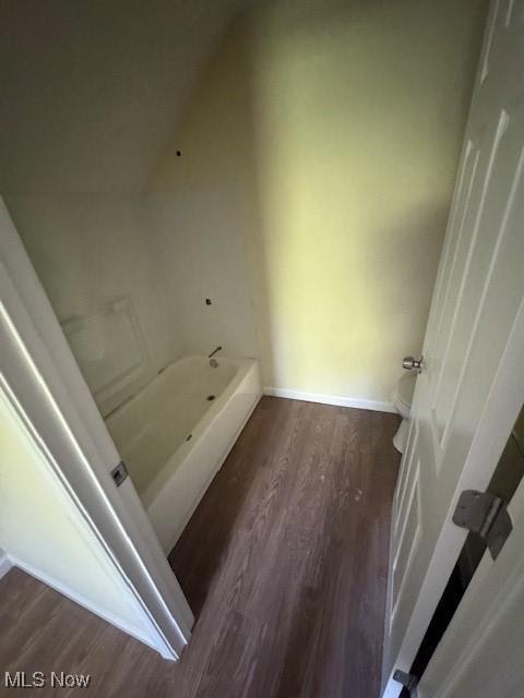 3213 W 46th St, Cleveland, OH 44102 - bathroom featuring wood finished floors, a tub, and baseboards