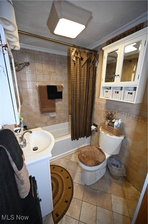 50277 Carroll Rd, East Liverpool, OH 43920 - bathroom featuring tile walls, ornamental molding, tile patterned floors, toilet, and shower / tub combo
